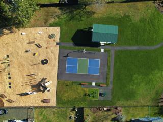 Overhead view of new park, including pickleball court, pavilion, and fitness station and playground equipment.