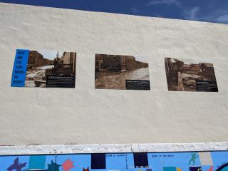 Historic picture panels on wall.