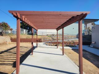 Pergola in Community Garden and newly poured concrete.