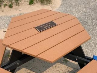 New picnic table with plaque.