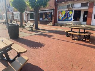 New benches and picnic tables, with storefront murals