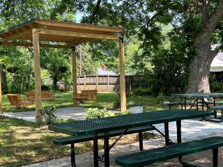 New picnic tables and gazebo with swings.