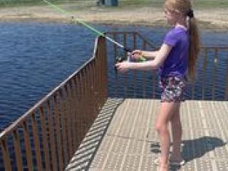 Child fishing from pier.