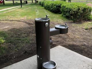 New water fountain with dog bowl.