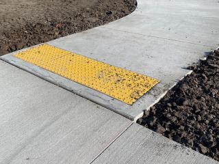 New sidewalk with raised detectable warnings.