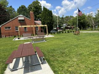 Bench, picnic table and swing benches at new pocket park.