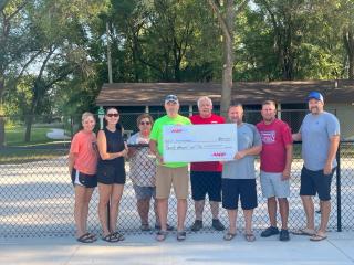 Presentation of large check at pickleball courts.