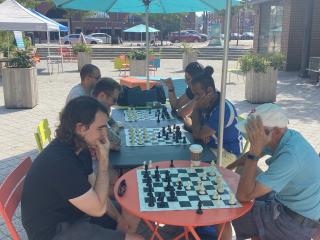 Group playing chess outside.