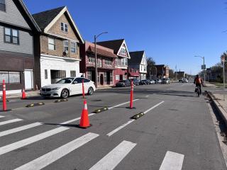 Pop-up traffic calming with traffic cones and delineators.