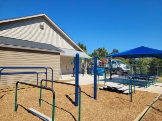 Finished outdoor exercise fitness area with picnic table and umbrella