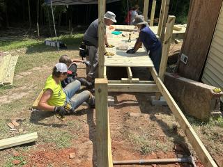 Volunteers building ramp to home.