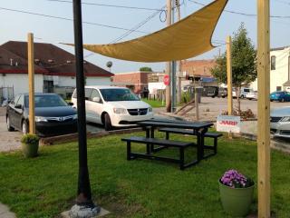 New picnic tables under shade sailcloth.