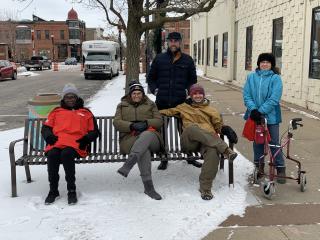 People sitting on new bench.