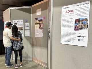 People looking at display of ADUs.