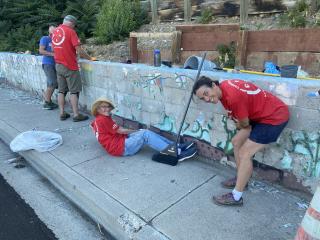 Volunteers painting the mural