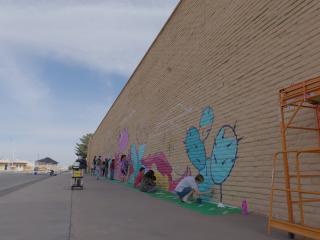 Volunteers painting mural.