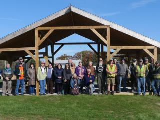 Group standing in front of new picnic pavilion.