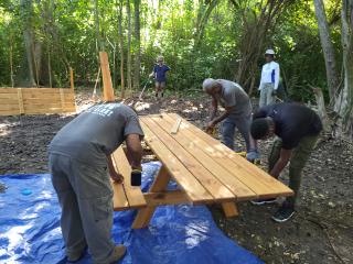 Volunteers assembling new picnic benches.