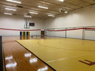 New gymnasium with pickleball net erected.