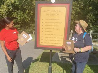 Volunteers near sign for Tobacco Heritage Trail.