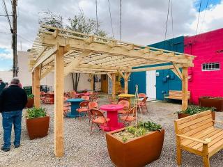 Alley with murals, shade structure, seating, and more.