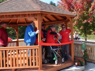 Ribbon cutting of gazebo with accessible ramp.