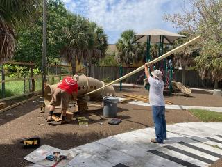 Volunteers installing playground equipment.
