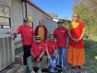 Group photo of older Laotian men with raised garden beds.