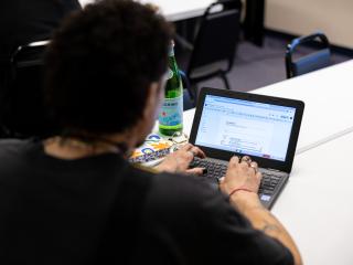 Participant using laptop in digital literacy class.
