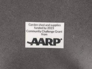 Sign acknowledging AARP funding.