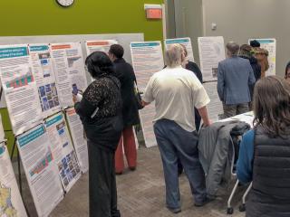 Community members looking at posterboards at Growing MKE open house