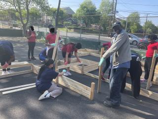 Students assembling garden beds.