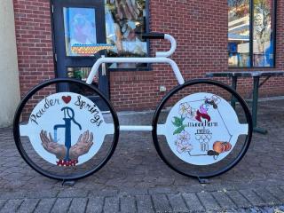 Painted bicycle-shaped bike rack.