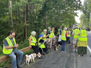 Group talking break on side of road during walk audit.