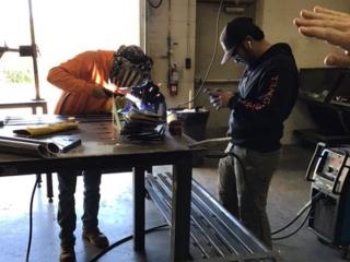 Students welding benches