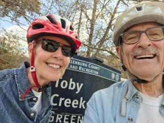 Two older adult bicyclists on Toby Creek Greenway.