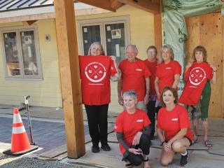 Board members wearing Challenge t-shirts at Community Center's rebuilt building.