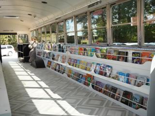Interior of book bus with books on shelves.