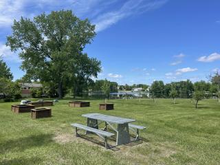 New community garden with raised beds and picnic tables.