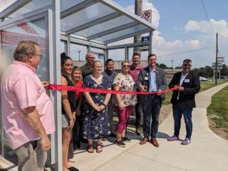 Ribbon cutting for new bus shelter.