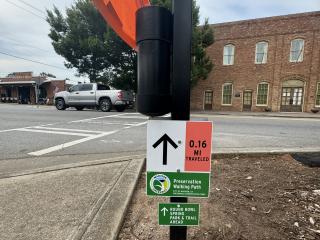 New directional signs and pedestrian crossing flags.