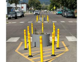 Temporary pedestrian refuge island in crosswalk.