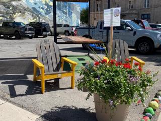 New chairs and planter next to bench swing.