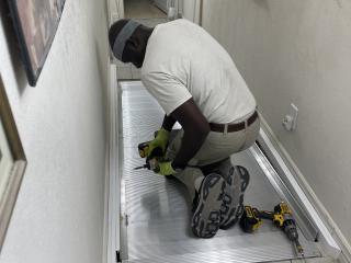 Installing a ramp in a hallway.