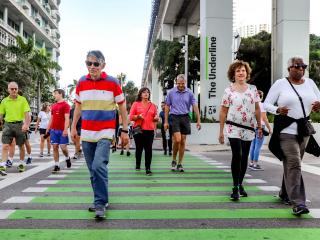 Walking club crossing the street along the Underline.