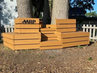 New circular bench around trees at community garden.