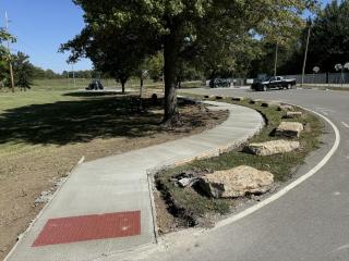 New sidewalk with tactile ramp.