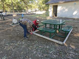 Assembling wooden forms for concrete pad for picnic table.