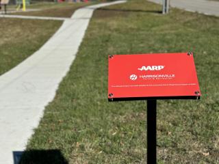 New sidewalk with AARP sign.