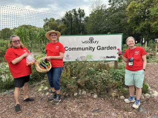 Volunteers with garden sign.